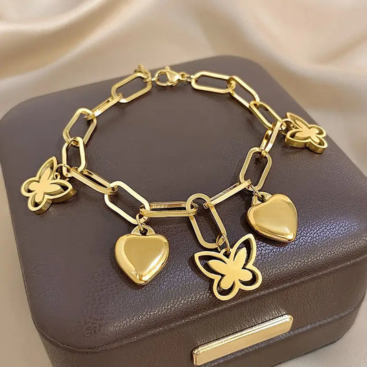 Elegant bracelet with butterfly and heart-shaped pendants